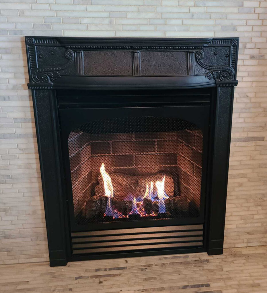 antique fireplace cover installed with gas fireplace