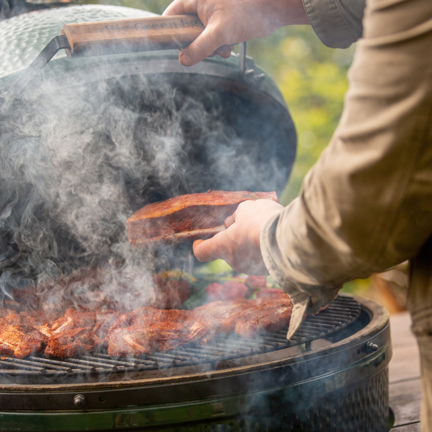 BIG GREEN EGG OPEN SMOKING WITH FOOD ON IT