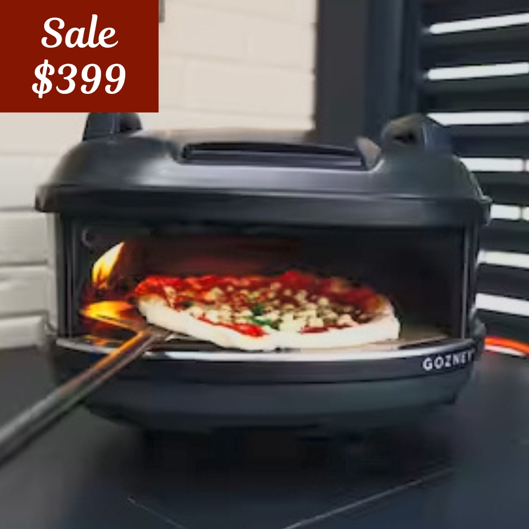 gozney tread pizza oven with pizza in it