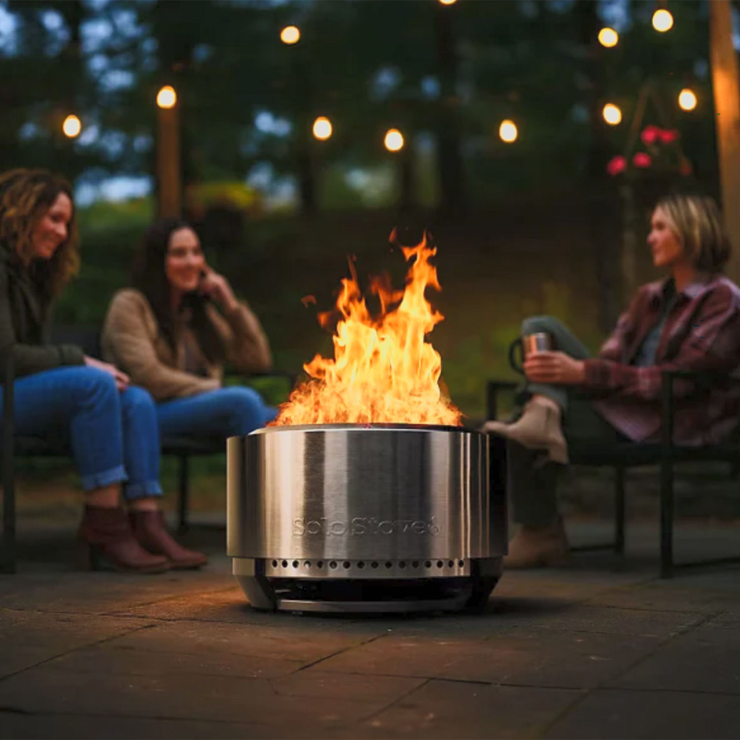 friends sitting around smokeless wood burning fire pit solo stove